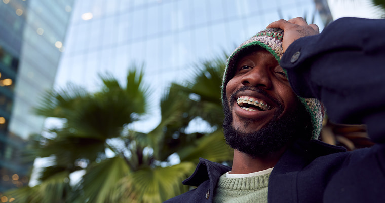 A man with braces laughing