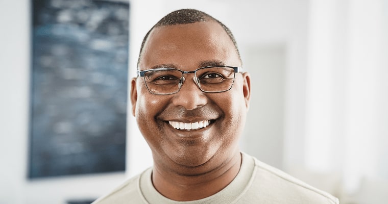 A man in glasses smiling